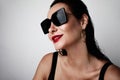 Fashion female model look. Glamour portrait of beautiful brunette womanl with bright makeup wearing sunglasses. Royalty Free Stock Photo