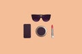 Fashion female set accessory, black sunglasses, blank black screen phone, red lipstick and little pocket mirror on brown Royalty Free Stock Photo