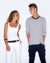 Fashion fever. Young trendy couple standing together on white background.