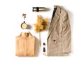 Fashion flat lay knolling with autumn and winter clothes - beige cozy sweater, plaid jacket or coat, coffee and accessories on