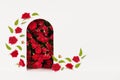 Fashion floral abstract stage with red roses as arch and podium mockup with flying buds and green leaves as flow on white.