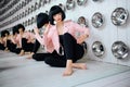 Fashion freak. Glamour synthetic girl, fake doll with empty look and short black hair is sitting in the studio. Stylish