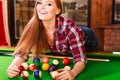 Young woman having fun with billiard.