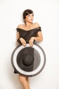 Fashion girl in a big hat in the studio Royalty Free Stock Photo
