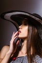 Fashion girl in a big hat in the studio Royalty Free Stock Photo