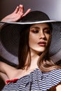 Fashion girl in a big hat in the studio Royalty Free Stock Photo