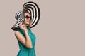 Fashion girl in a big hat and sunglasses on a colored background. Royalty Free Stock Photo