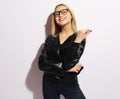 Fashion girl in black clothing. Leather jacket and pants, blank t-shirt and sunglasses. Royalty Free Stock Photo