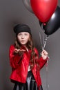 Fashion Girl with color balloons wink. Studio photo on a dark background