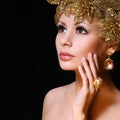 Fashion Girl with Gold Jewelries. Beauty young woman Royalty Free Stock Photo