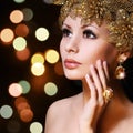 Fashion Girl with Gold Jewelries. Beauty young woman Royalty Free Stock Photo