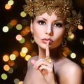 Fashion Girl with Gold Jewelries over bokeh background. Beauty Royalty Free Stock Photo