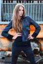 Fashion girl in a jacket next to the construction Royalty Free Stock Photo