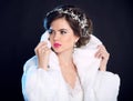 Fashion girl model in white fur coat, luxury jewelry, elegant ha Royalty Free Stock Photo
