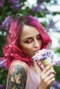 Fashion girl with red hair and big hat, spring portrait in lilac colors in summer. Beautiful red pink dress, tattoos on the body Royalty Free Stock Photo