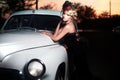 Fashion girl in retro style posing near old car Royalty Free Stock Photo