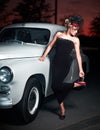 Fashion girl in retro style posing near old car Royalty Free Stock Photo
