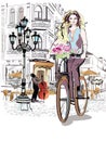 Fashion girl rides a bicycle the streets of the old town. Royalty Free Stock Photo