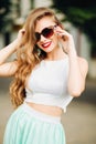 Fashion and glamour girl in sunglasses with red lips posing.
