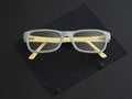 Glasses yellow and gray color plastic frame lies.