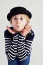 Fashion, goofy and girl child in a studio with casual, cool and stylish jersey outfit and hat. Silly, comic and funny