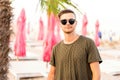 Fashion guy on the beach walking in sunglasses Royalty Free Stock Photo