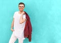 Fashion guy in glasses poses near the wall the color of the sour Royalty Free Stock Photo