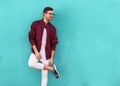 Fashion guy in glasses poses near the wall the color of the sour Royalty Free Stock Photo