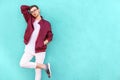 Fashion guy in glasses poses near the wall the color of the sour Royalty Free Stock Photo