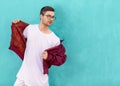 Fashion guy in glasses poses near the wall the color of the sour Royalty Free Stock Photo