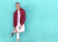 Fashion guy in glasses poses near the wall the color of the sour Royalty Free Stock Photo