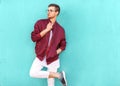 Fashion guy in glasses poses near the wall the color of the sour Royalty Free Stock Photo