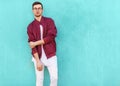 Fashion guy in glasses poses near the wall the color of the sour Royalty Free Stock Photo