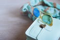 Fashion handbag with glasses, scarf, beads on gray wooden table. Background Royalty Free Stock Photo