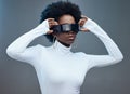 Fashion, hands and black woman with futuristic sunglasses, gen z and stylish with trendy designer brand against studio