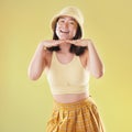 Fashion, hands on face and portrait of woman with comic eyes isolated on yellow background. Happy, funny and asian girl