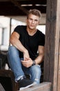 Fashion handsome young man with hair in a black shirt and jeans Royalty Free Stock Photo