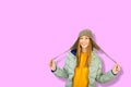 Fashion happy smiling young woman in winter clothes on pink background Royalty Free Stock Photo