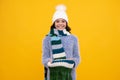 Fashion happy young woman in knitted hat and sweater having fun over colorful blue background. Happy girl face, positive Royalty Free Stock Photo