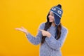 Fashion happy young woman in knitted hat and sweater having fun over colorful blue background. Happy face, positive and Royalty Free Stock Photo