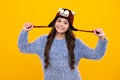 Fashion happy young woman in knitted hat and sweater having fun over colorful blue background. Happy teenager, positive Royalty Free Stock Photo