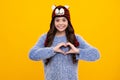 Fashion happy young woman in knitted hat and sweater having fun over colorful blue background. Happy teenager, positive Royalty Free Stock Photo