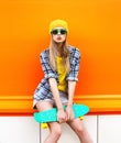 Fashion hipster cool girl in sunglasses and colorful clothes