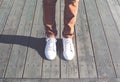 Fashion hipster cool man with white sneakers close-up stands