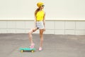 Fashion hipster cool woman with skateboard