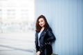 Fashion hipster woman posing outdoor. leather jacket,brunette hair, bright red lips.Street fashion concept. Royalty Free Stock Photo