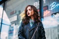 Fashion hipster woman posing outdoor. leather jacket,brunette hair, bright red lips, sunglasses.Trendy fashion style Royalty Free Stock Photo