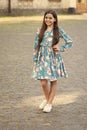 Fashion inspired by you. Fashion look of little girl. Happy child with long hair smile urban outdoors. Summer fashion