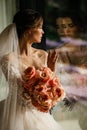 Beautiful young bride with dark hair in luxurious wedding dress with bouquet of flowers Royalty Free Stock Photo