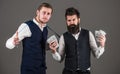 Fashion investments concept. Man with beard and young macho Royalty Free Stock Photo